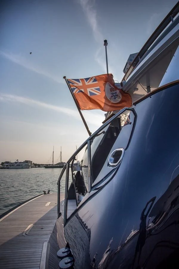 a boat with a flag on the front aboard HELIOS 2 Yacht for Sale