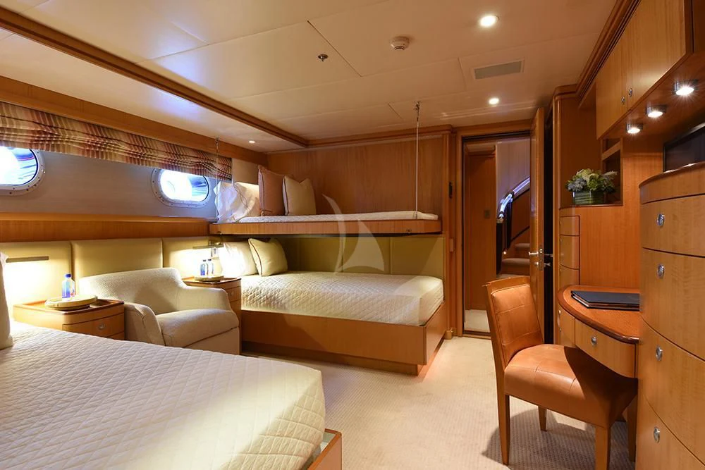 a room with a bed and a chair aboard HELIOS 2 Yacht for Sale