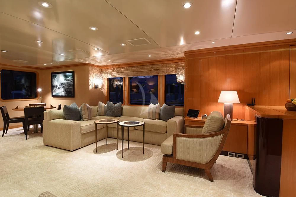 a living room with a large sofa and a large screen aboard HELIOS 2 Yacht for Sale