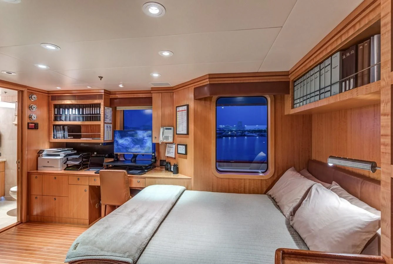 a bedroom with a bed and a tv aboard HELIOS 2 Yacht for Sale