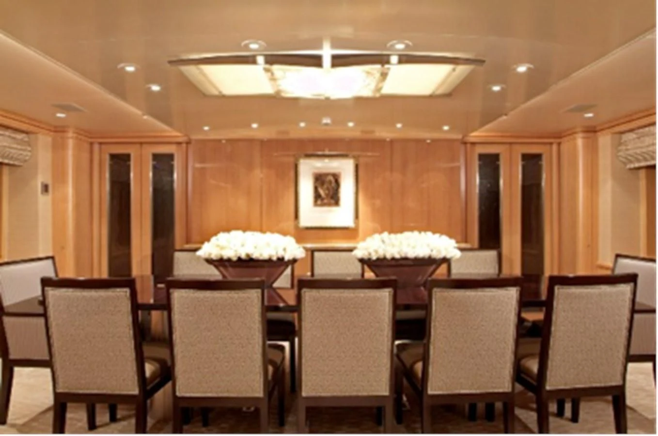 a large room with a table and chairs and a large white cake on top of it aboard HELIOS 2 Yacht for Sale