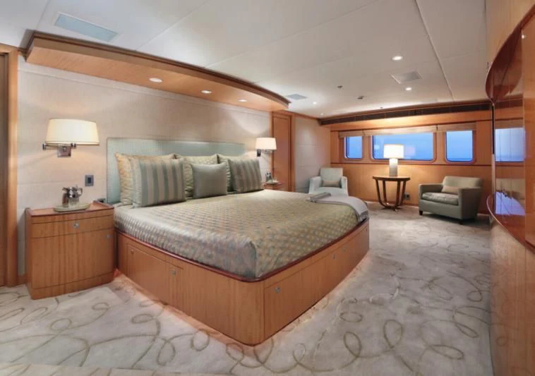 a large bedroom with a bed and a desk aboard HELIOS 2 Yacht for Sale