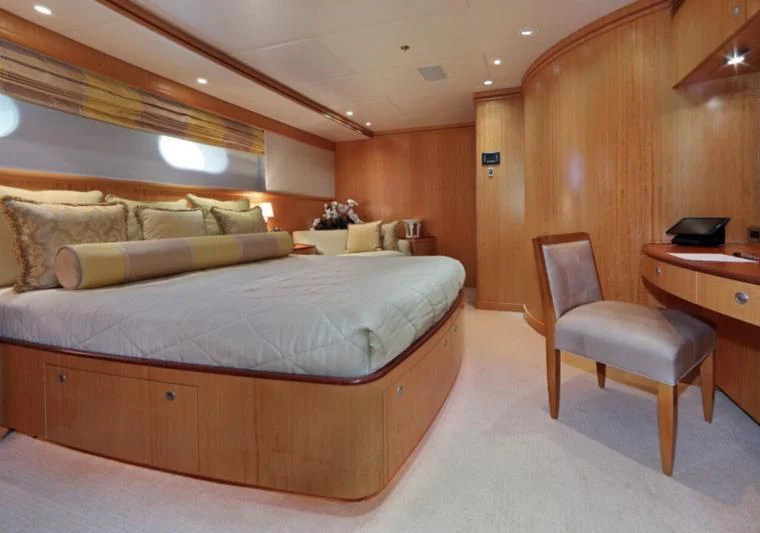 a bed with a chair and a desk in a room aboard HELIOS 2 Yacht for Sale