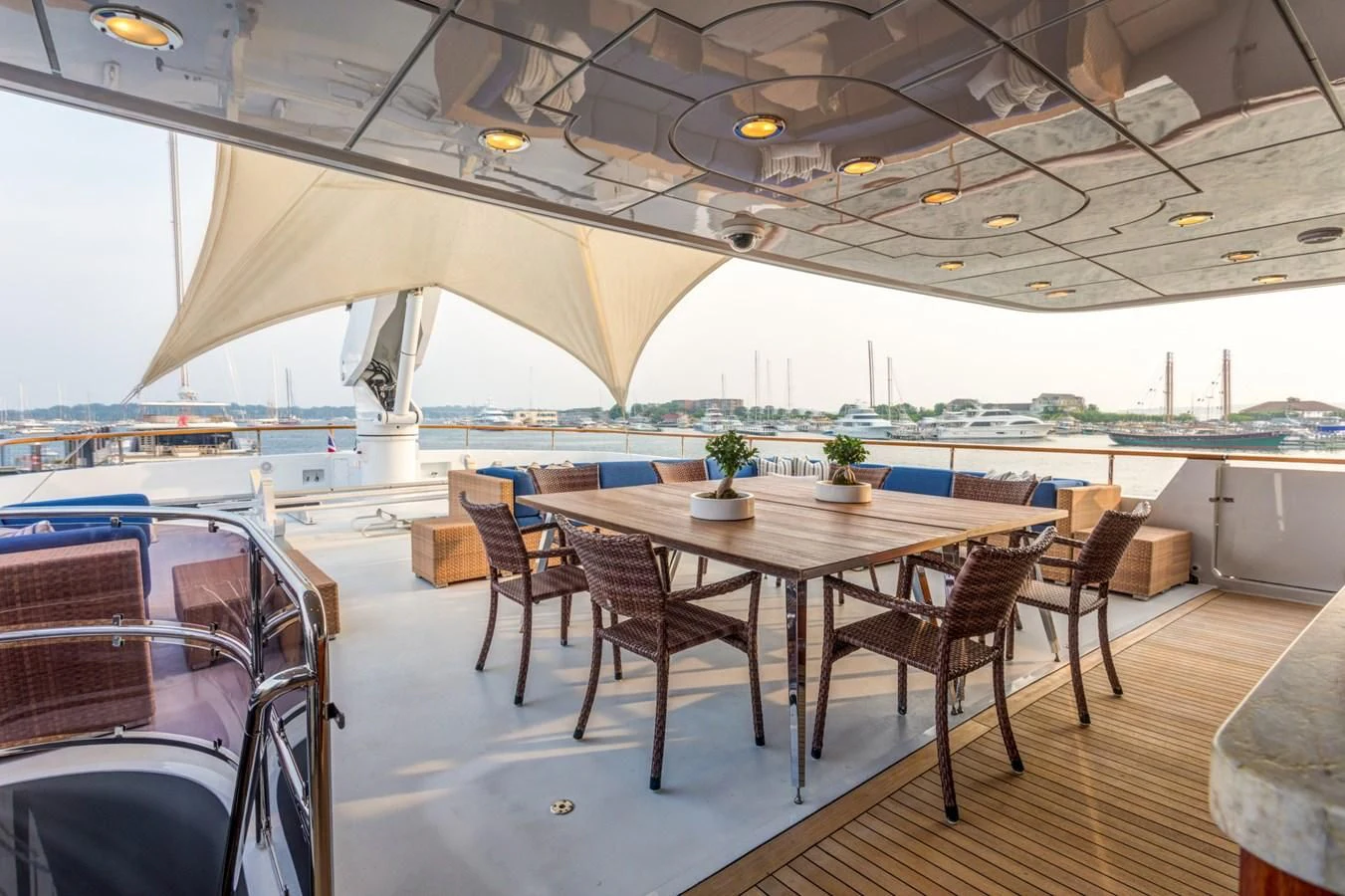 a table and chairs on a deck aboard HELIOS 2 Yacht for Sale