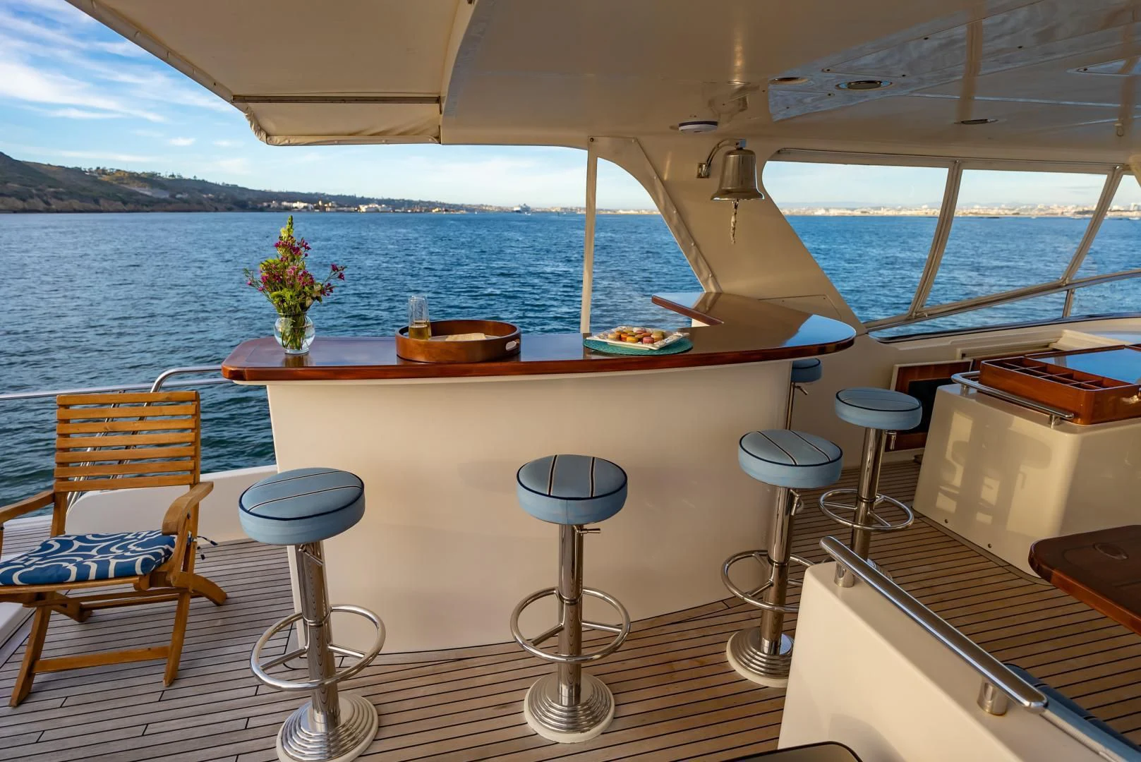 a table with stools on it next to a body of water aboard HALCYON SEAS Yacht for Sale