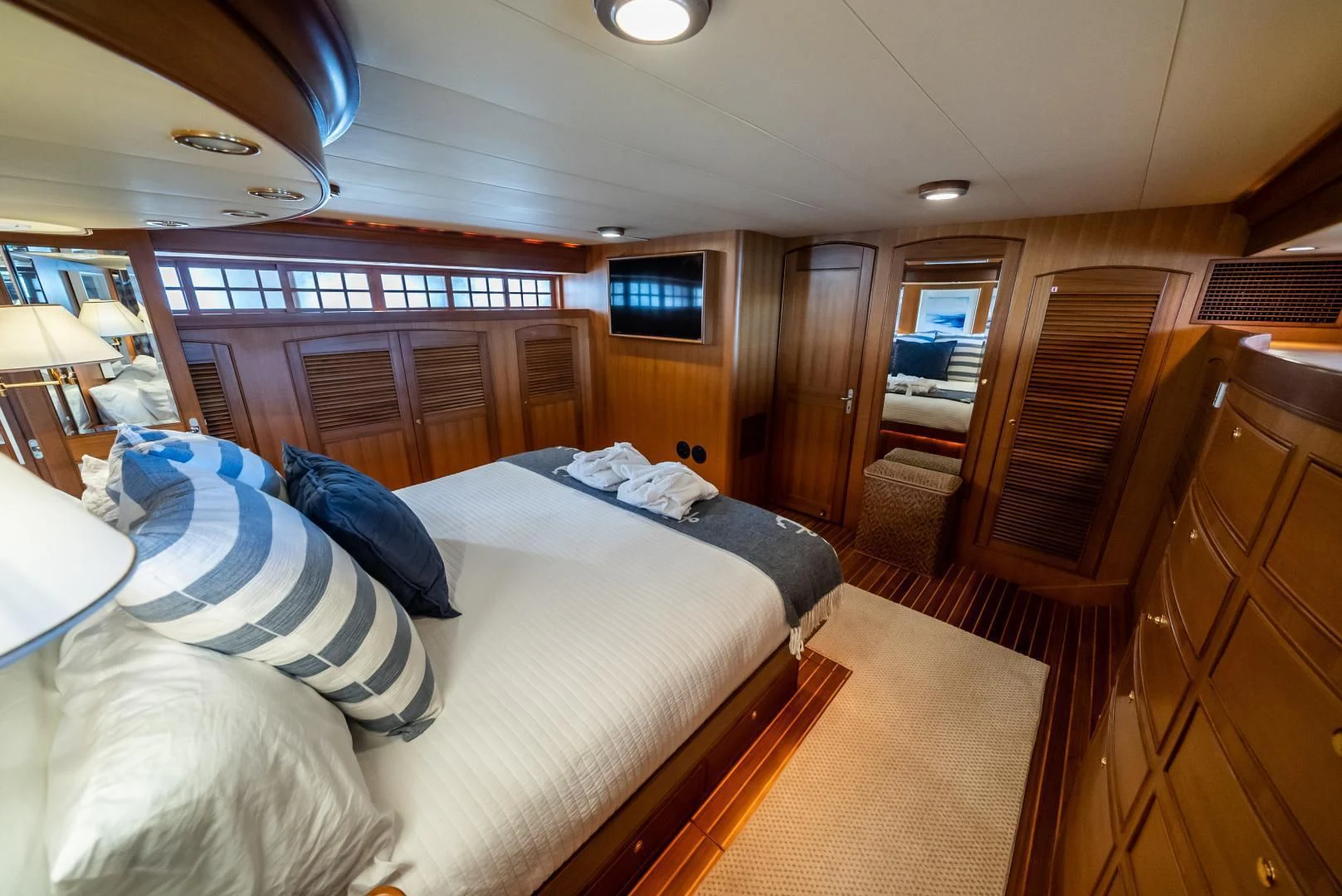 a room with a bed and a wood cabinet aboard HALCYON SEAS Yacht for Sale