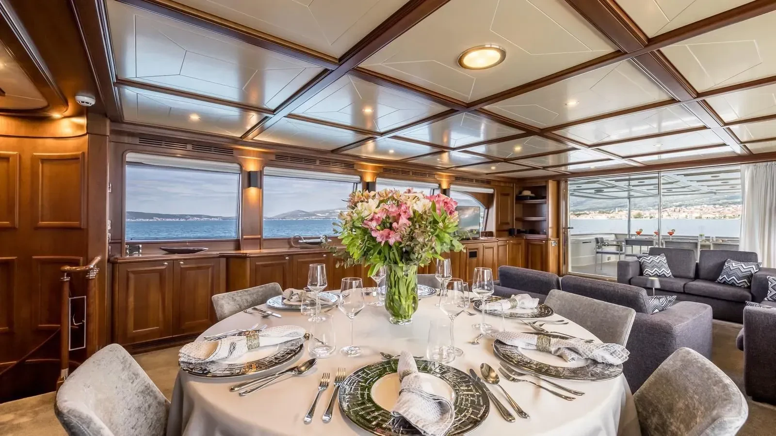 a dining room with a large window aboard KLOBUK Yacht for Charter