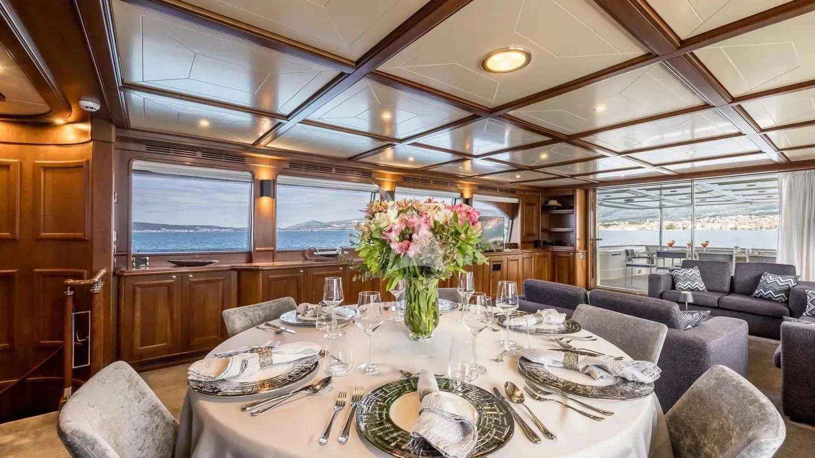 a large dining room with a large window aboard KLOBUK Yacht for Charter