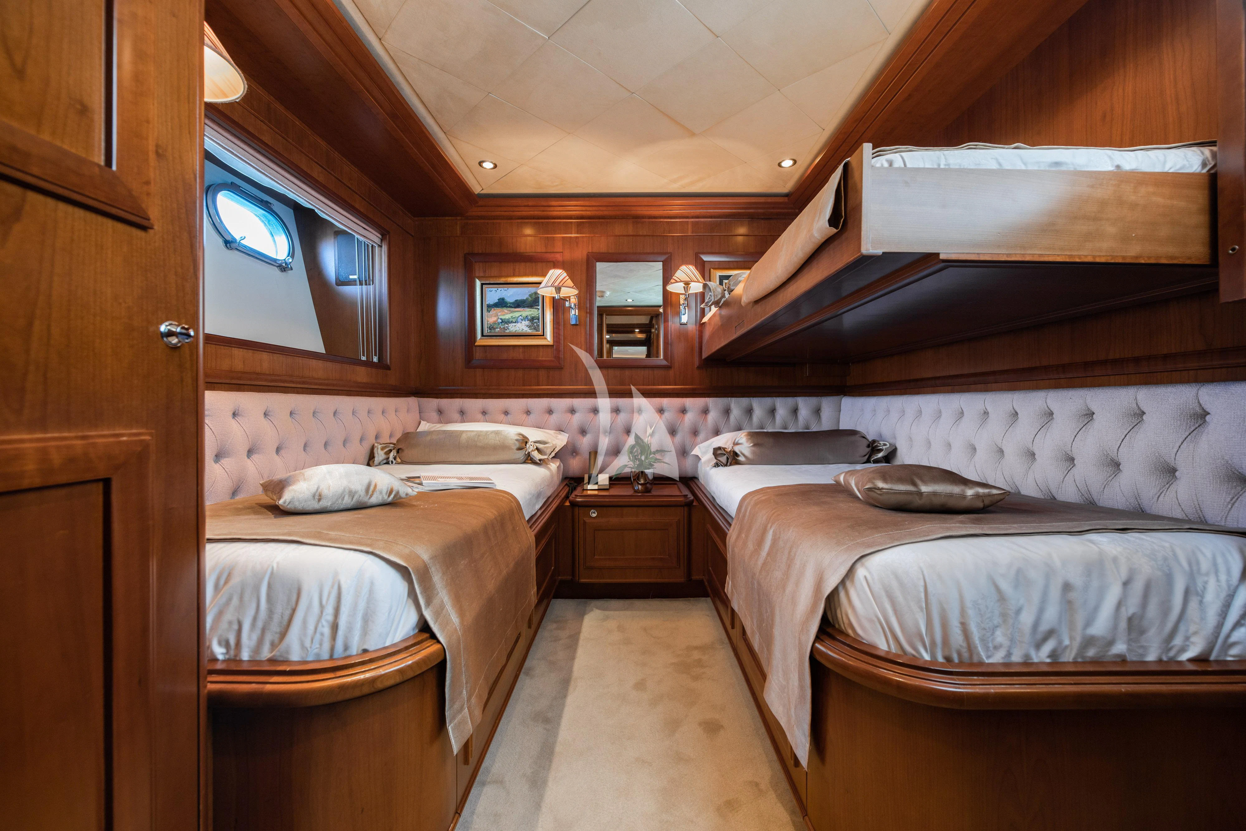 a room with beds and a window aboard KLOBUK Yacht for Charter