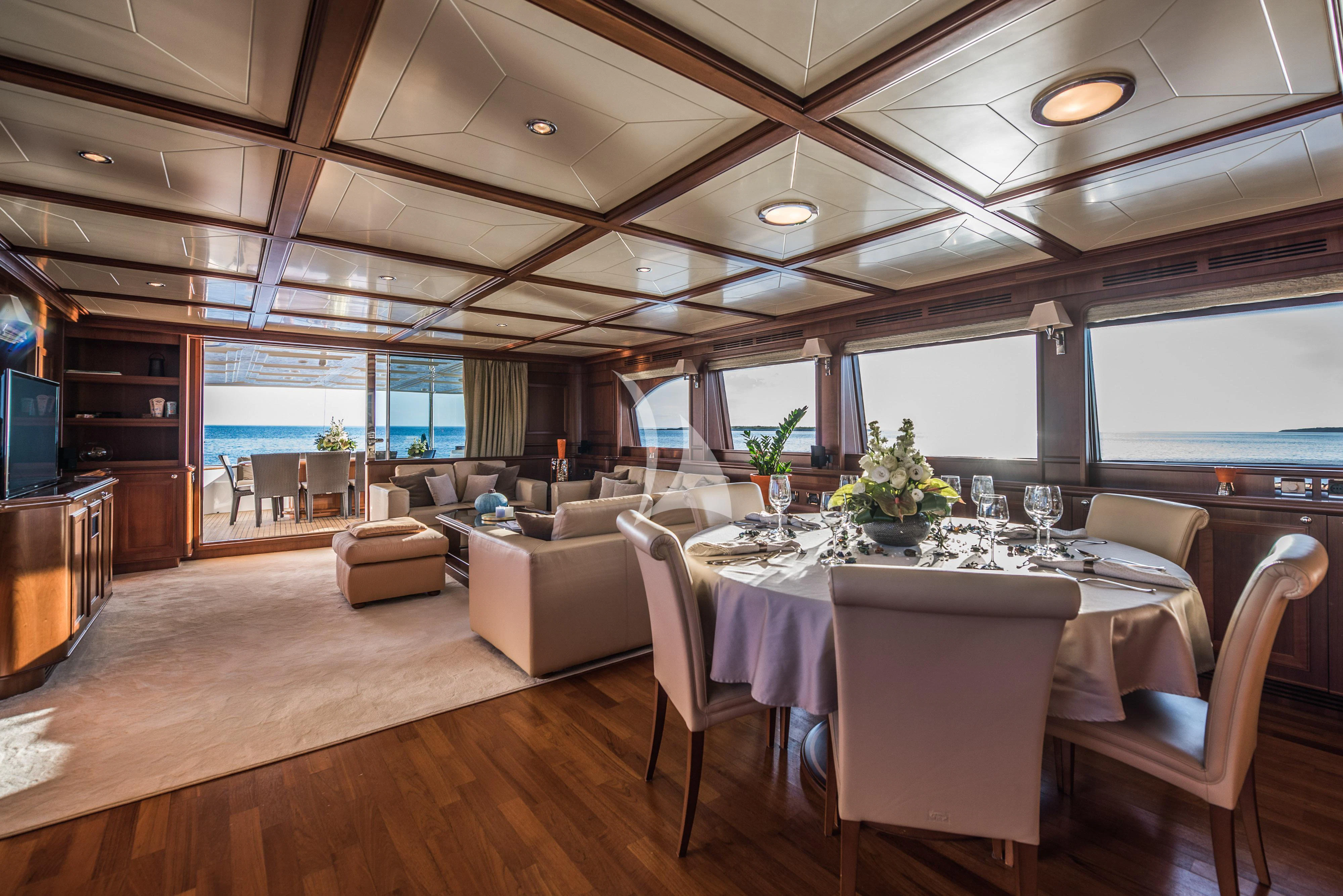 a large room with a table and chairs aboard KLOBUK Yacht for Charter