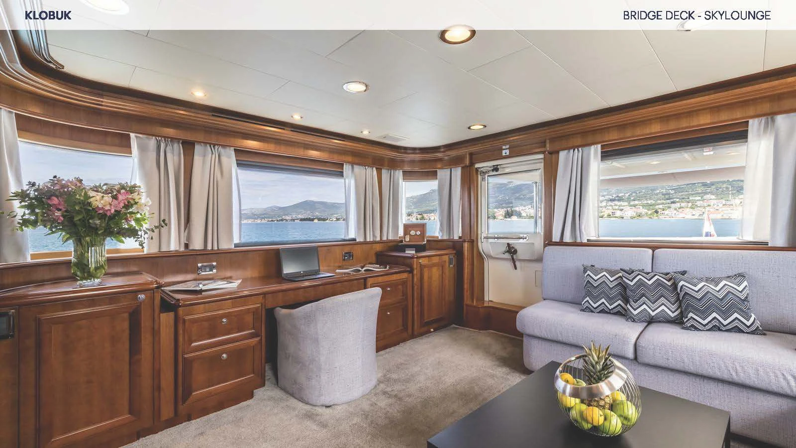 a living room with a couch and a table aboard KLOBUK Yacht for Charter