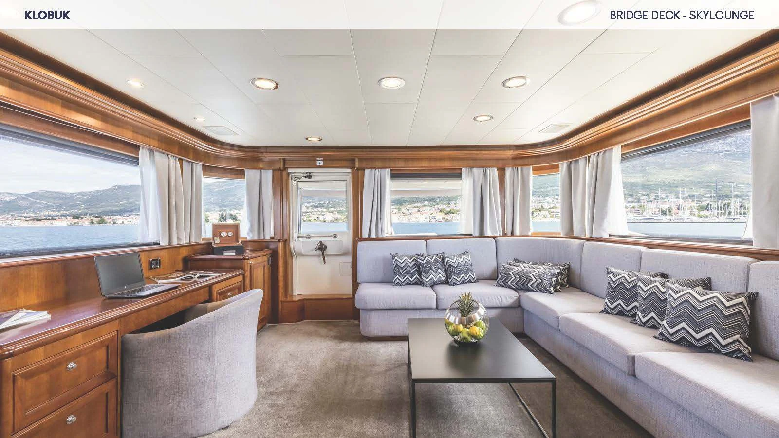 a living room with a couch and a table aboard KLOBUK Yacht for Charter