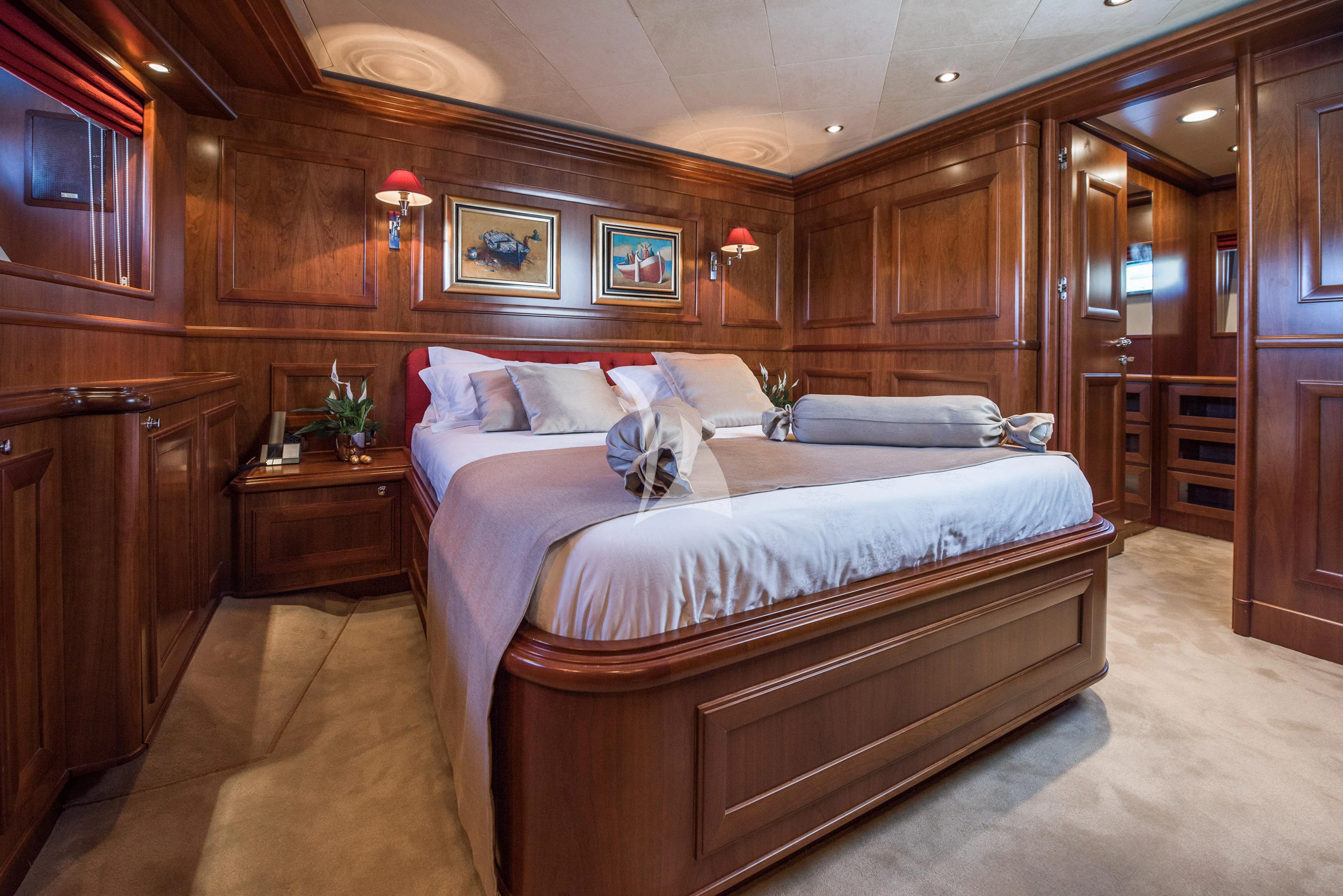 a bedroom with a bed and a wood wall aboard KLOBUK Yacht for Charter