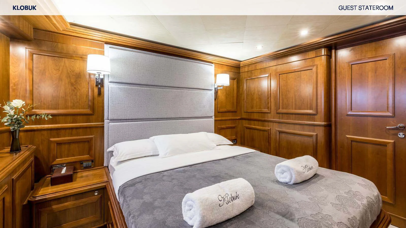 a bed with white sheets aboard KLOBUK Yacht for Charter