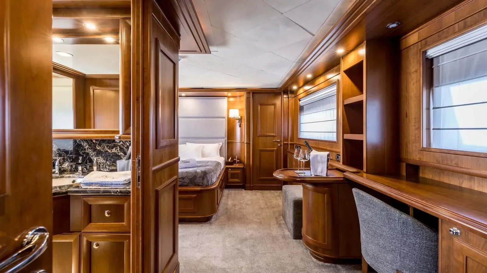 a room with a bed and desk aboard KLOBUK Yacht for Charter