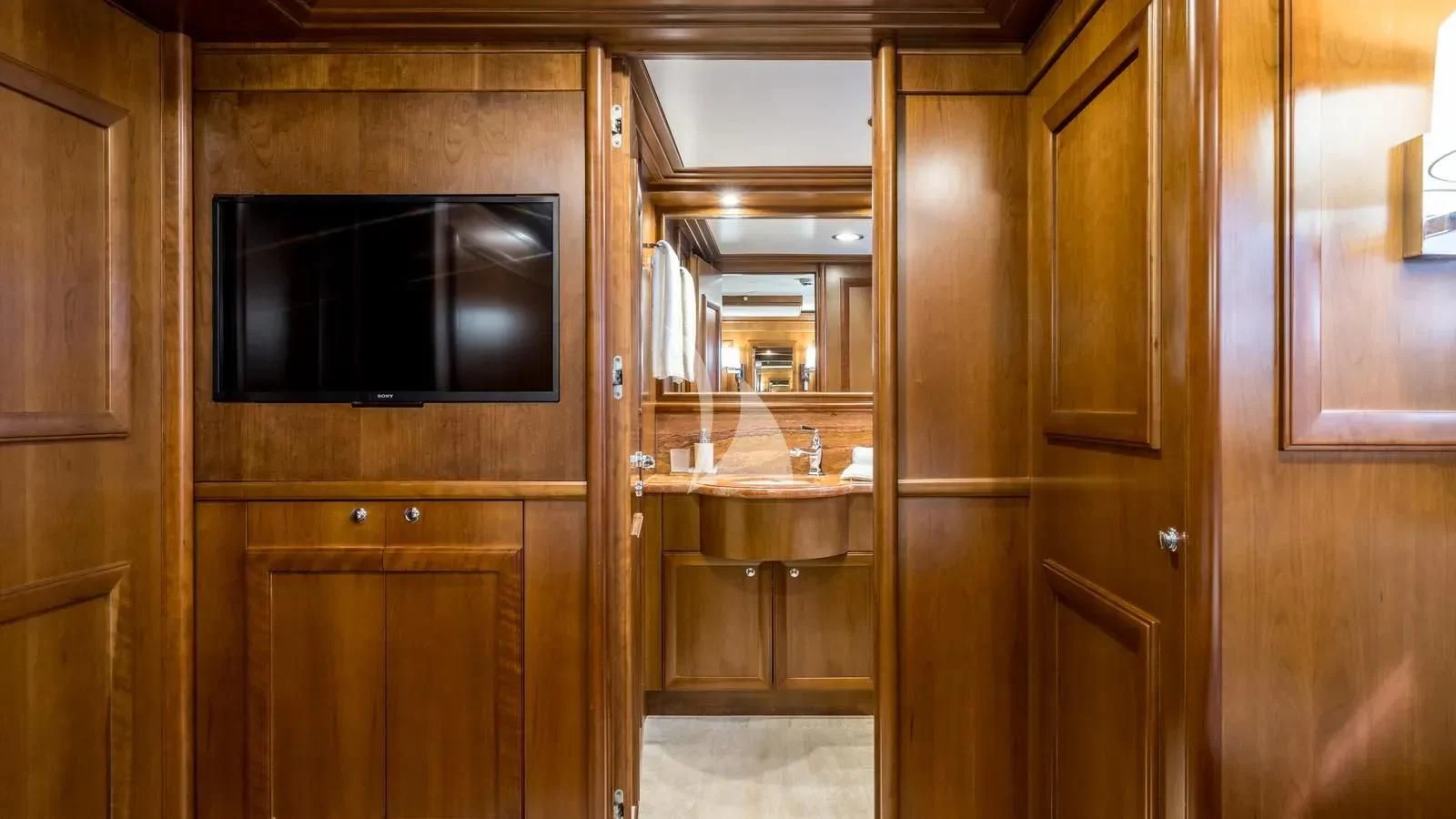 a kitchen with wooden cabinets aboard KLOBUK Yacht for Charter