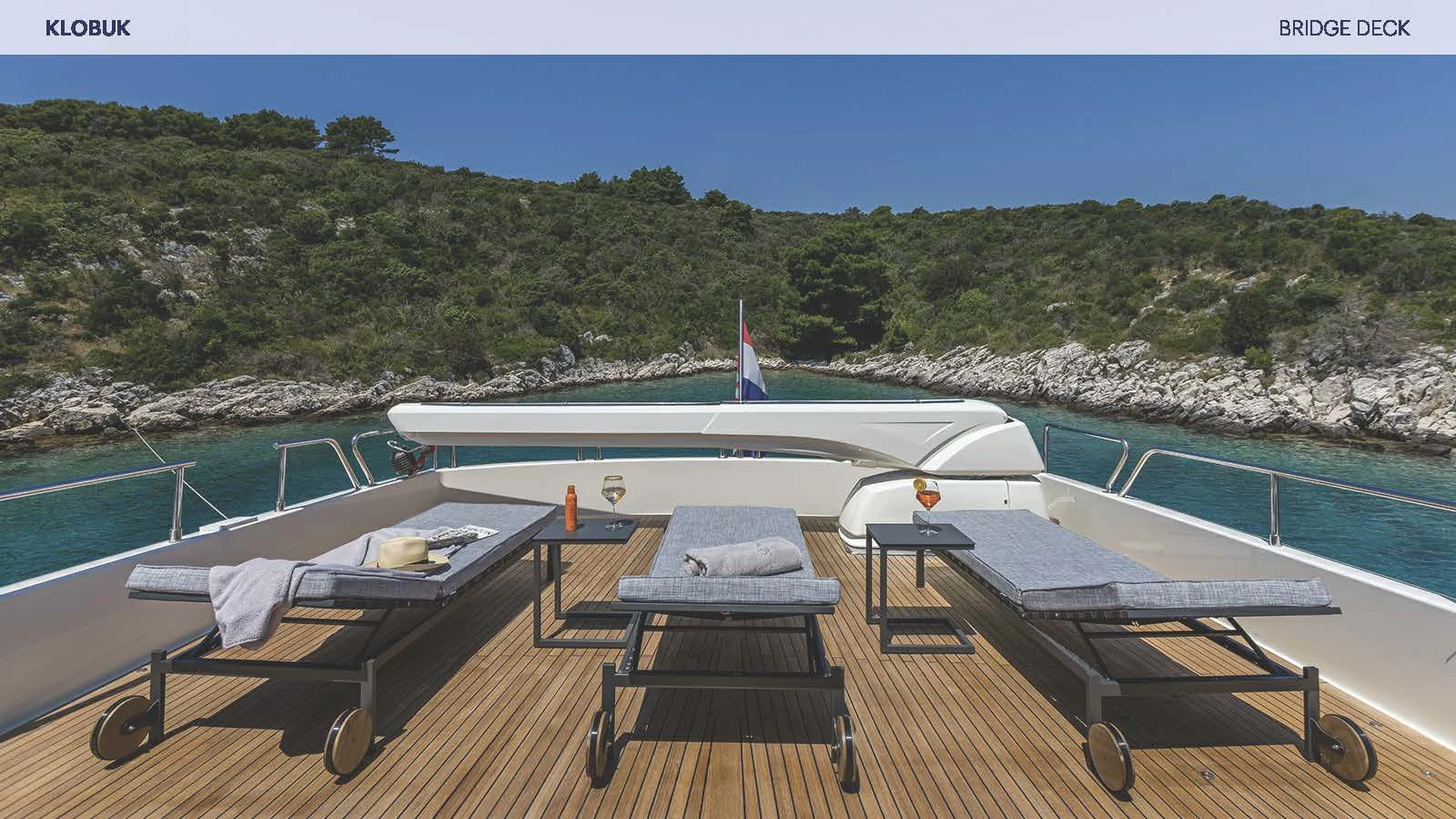 a deck with a pool and a plane on it aboard KLOBUK Yacht for Charter