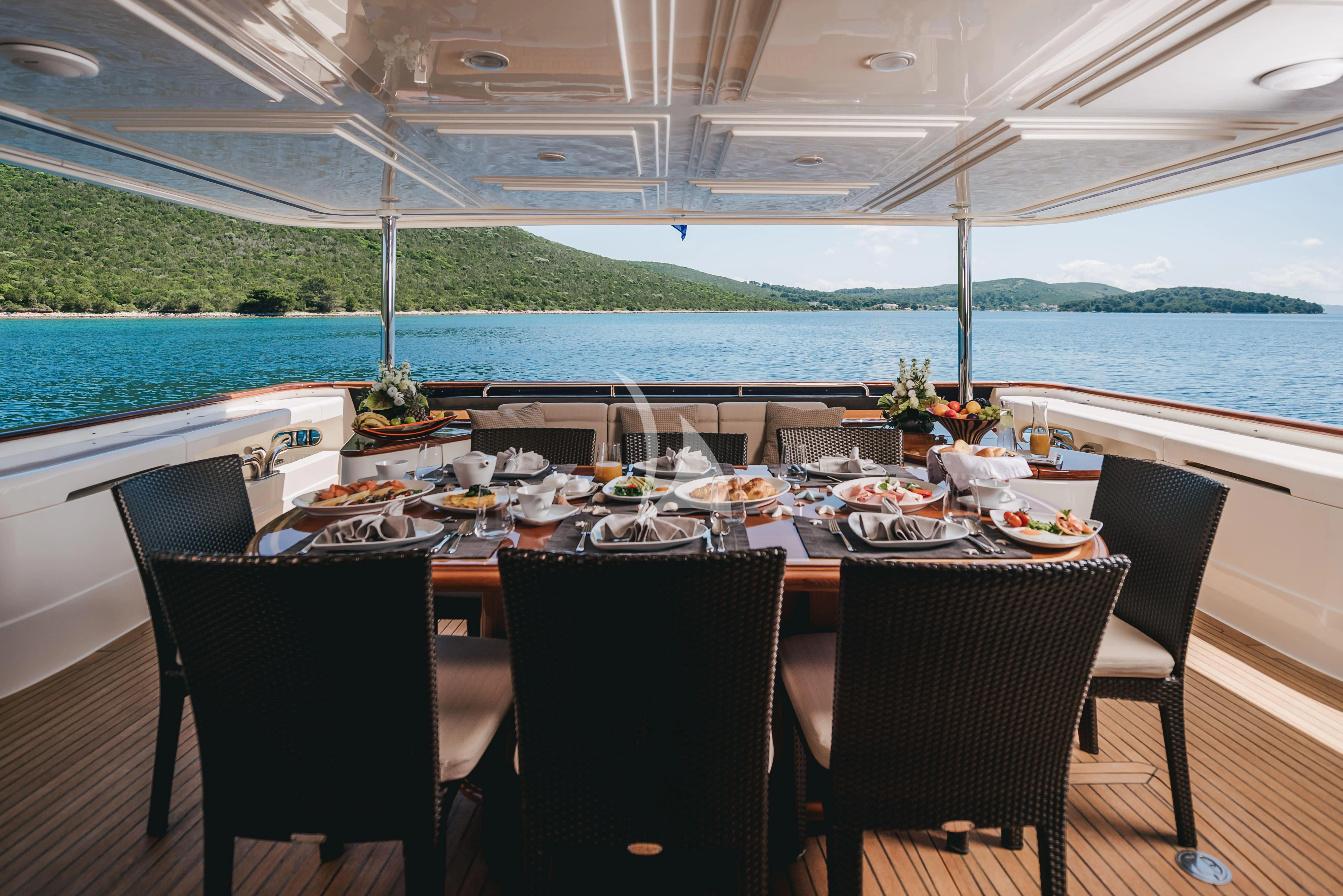 a table set for a meal on a boat aboard KLOBUK Yacht for Charter