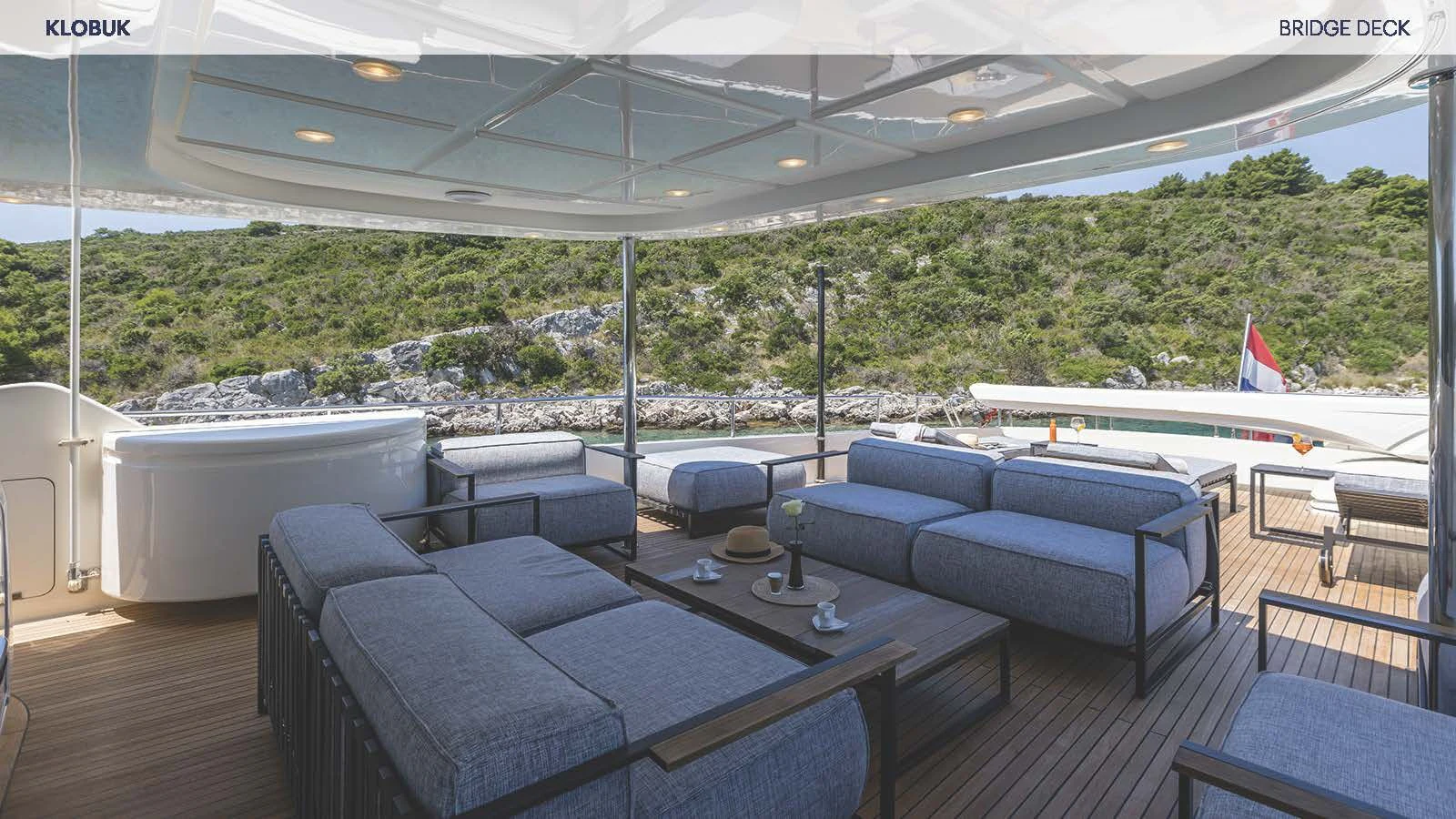 a large room with couches and a pool aboard KLOBUK Yacht for Charter