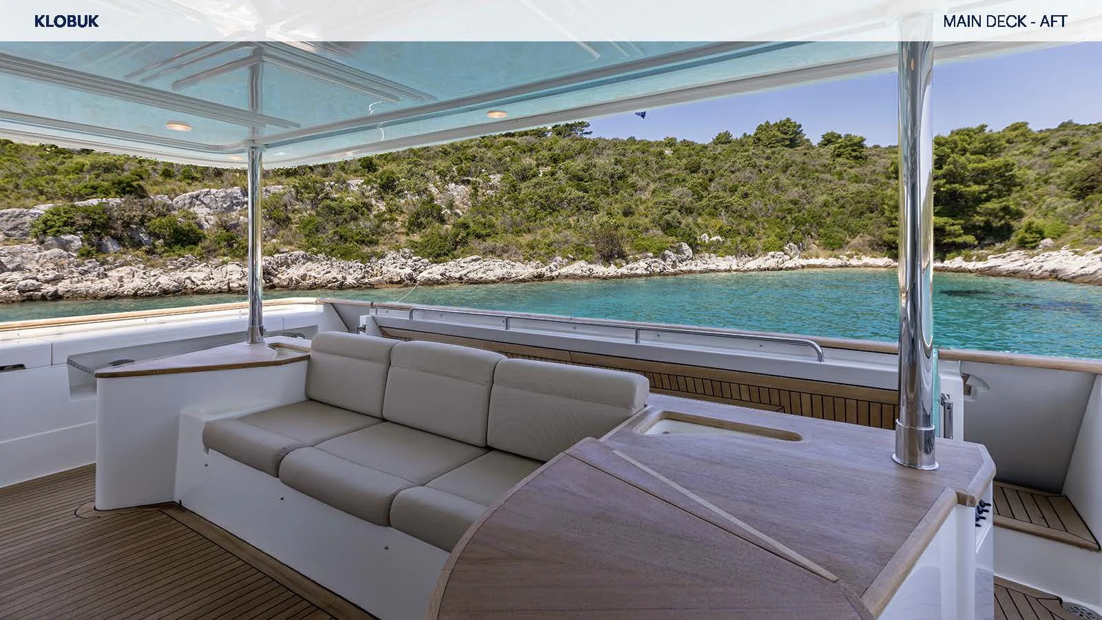 a lounge chair on a deck overlooking a body of water aboard KLOBUK Yacht for Charter