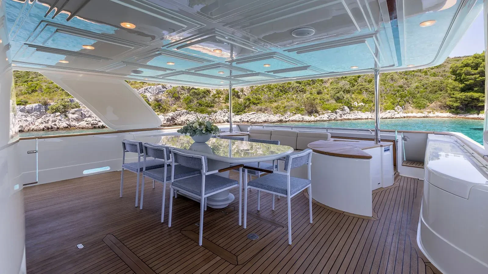 a table and chairs on a deck aboard KLOBUK Yacht for Charter