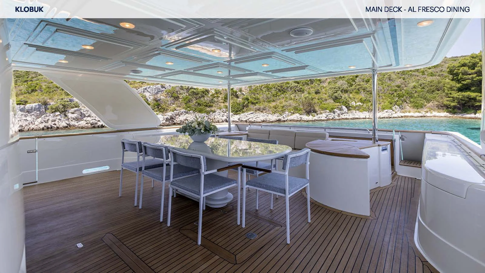 a table and chairs on a deck aboard KLOBUK Yacht for Charter