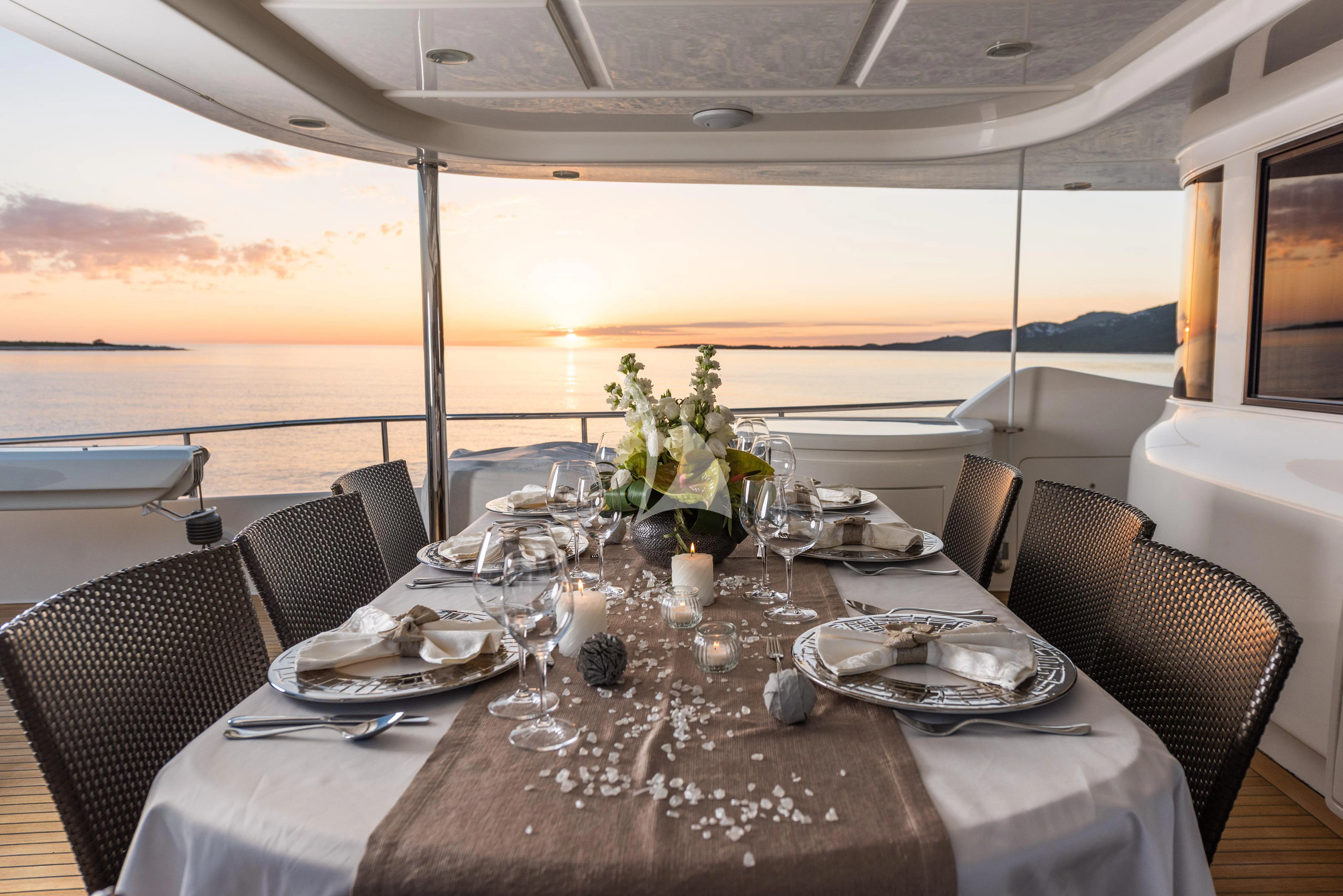 a table set for a dinner aboard KLOBUK Yacht for Charter