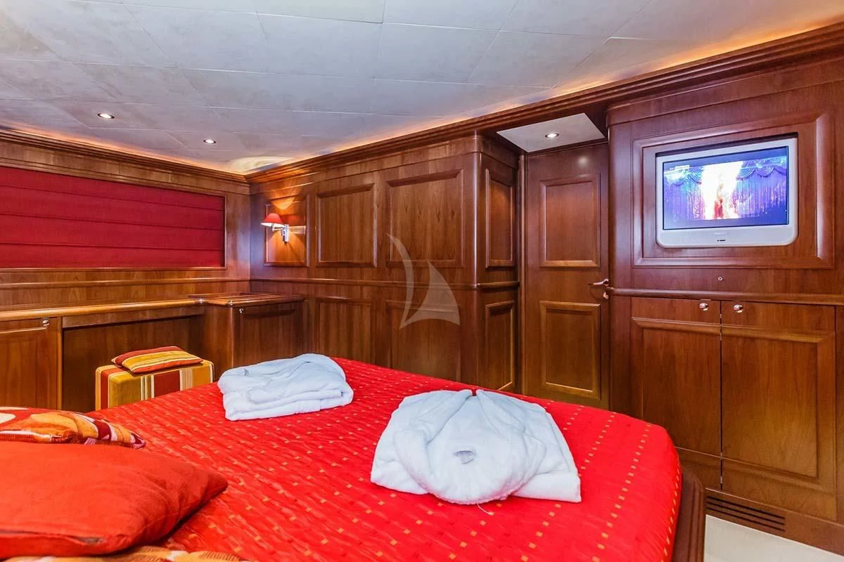 a bedroom with a television and a bed aboard KLOBUK Yacht for Charter