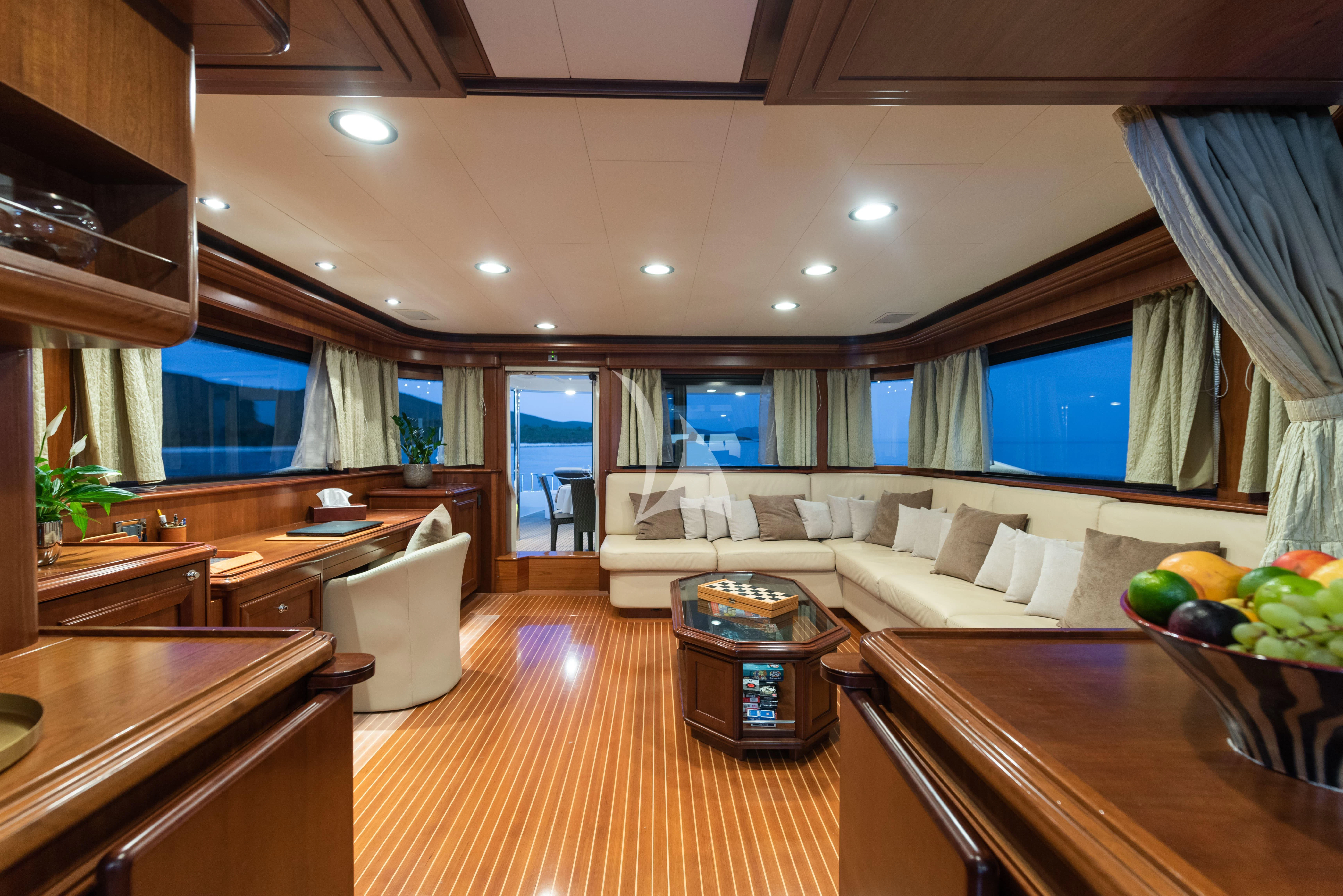 a large living room with a large window aboard KLOBUK Yacht for Charter