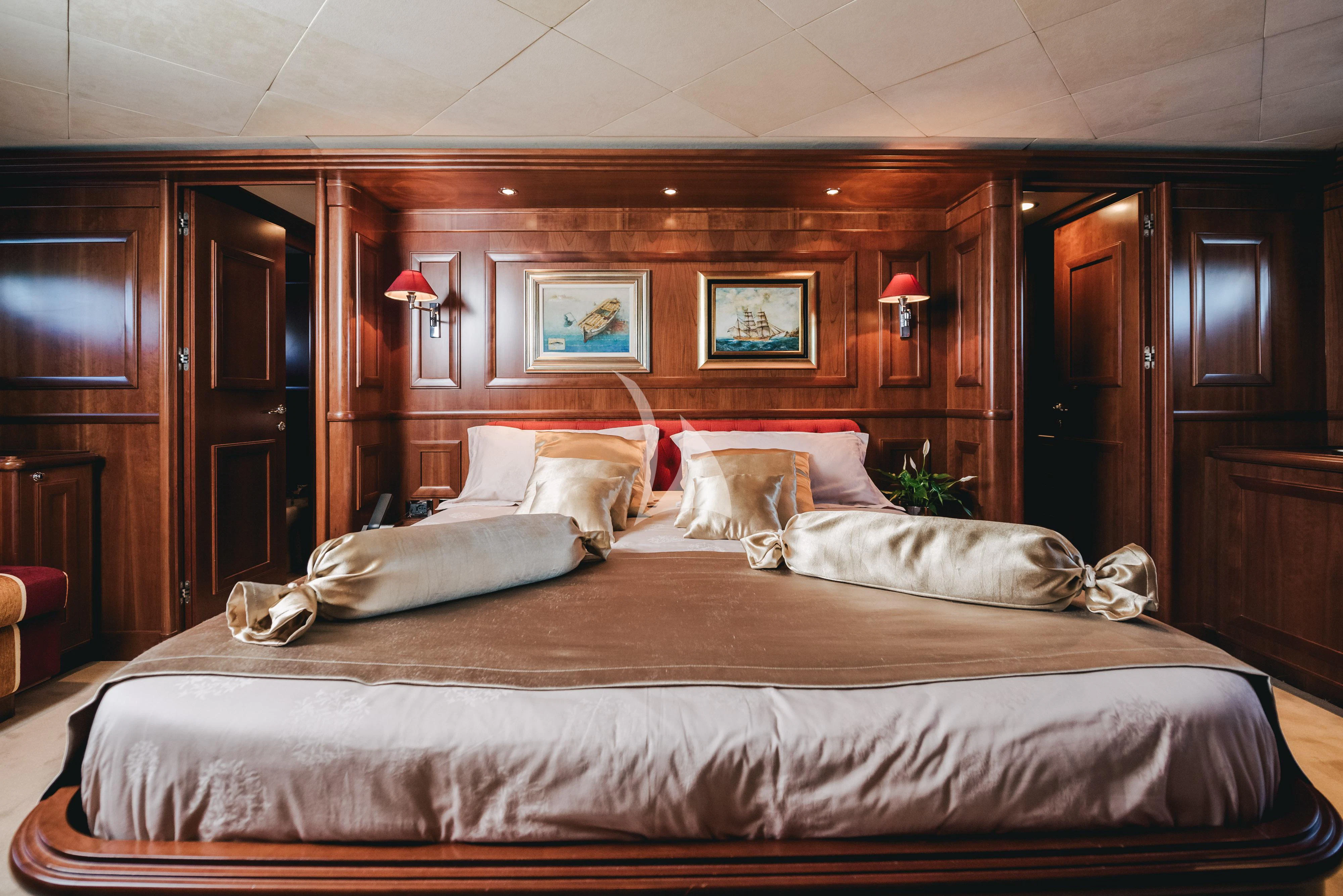 a large bed with a couple of pillows on it aboard KLOBUK Yacht for Charter