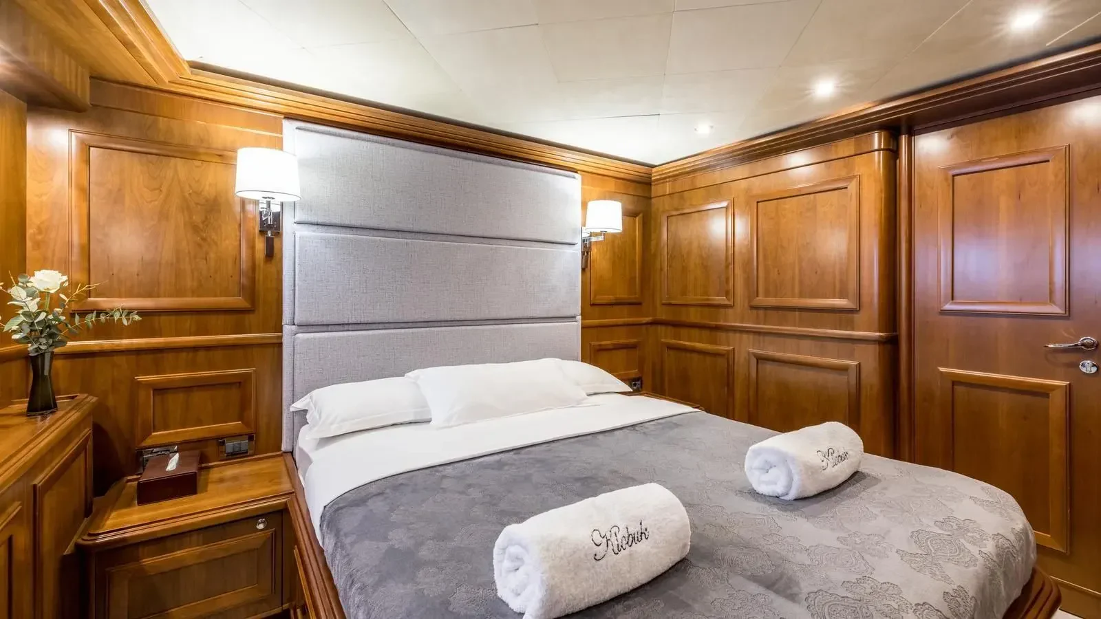 a bed with white sheets aboard KLOBUK Yacht for Charter