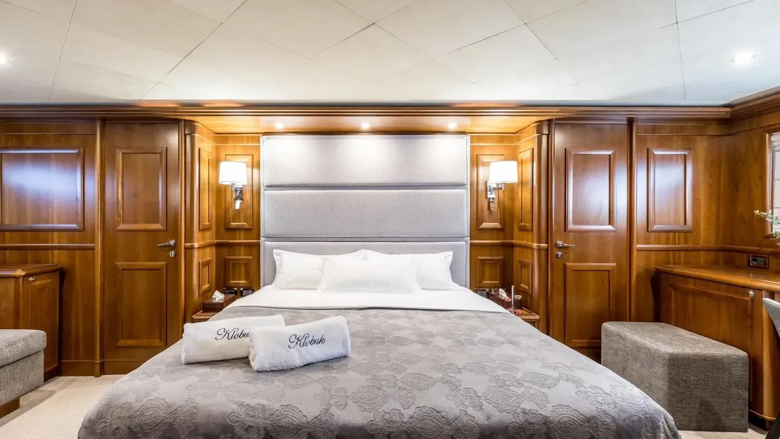 a bed with white sheets aboard KLOBUK Yacht for Charter