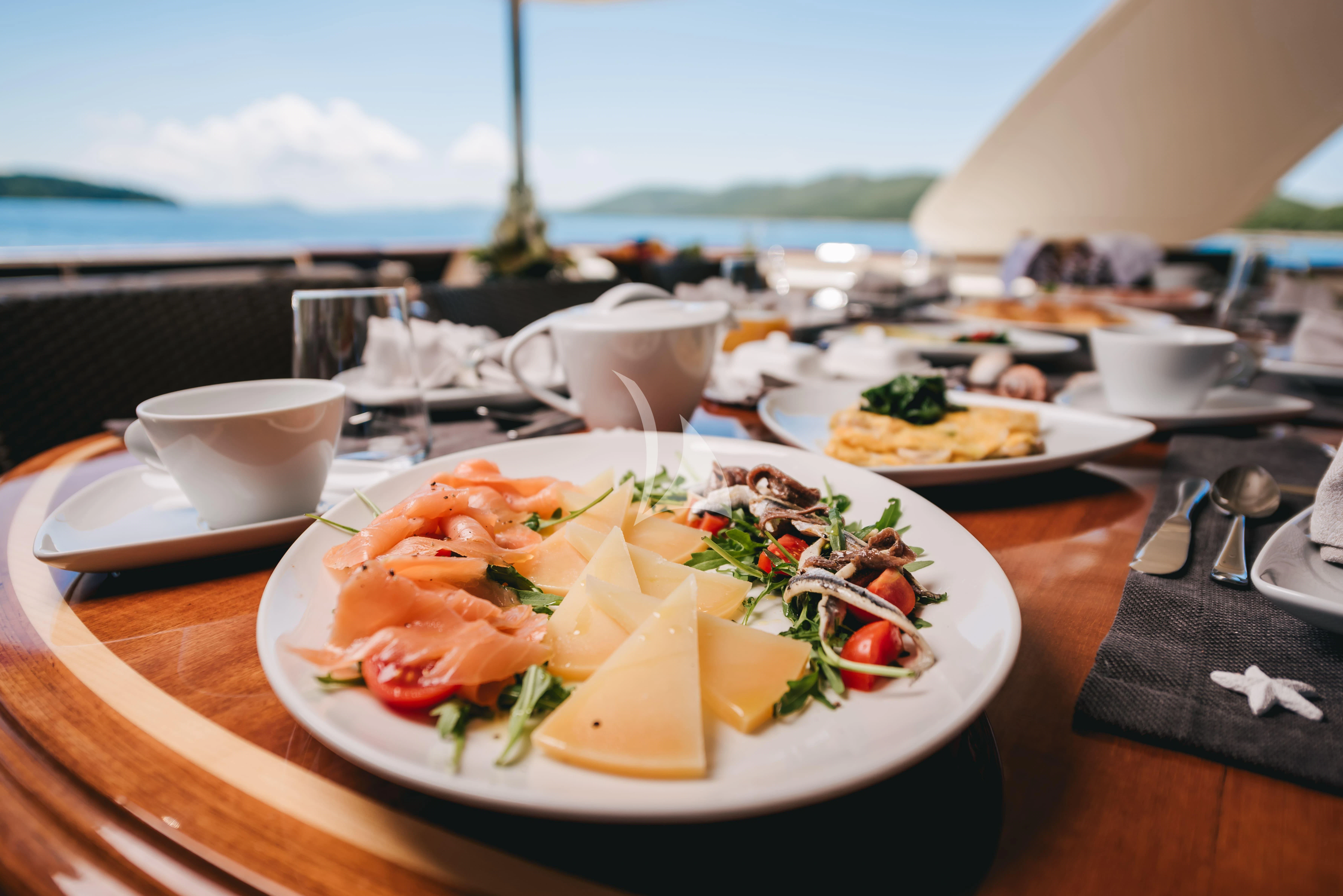 a table full of food aboard KLOBUK Yacht for Charter