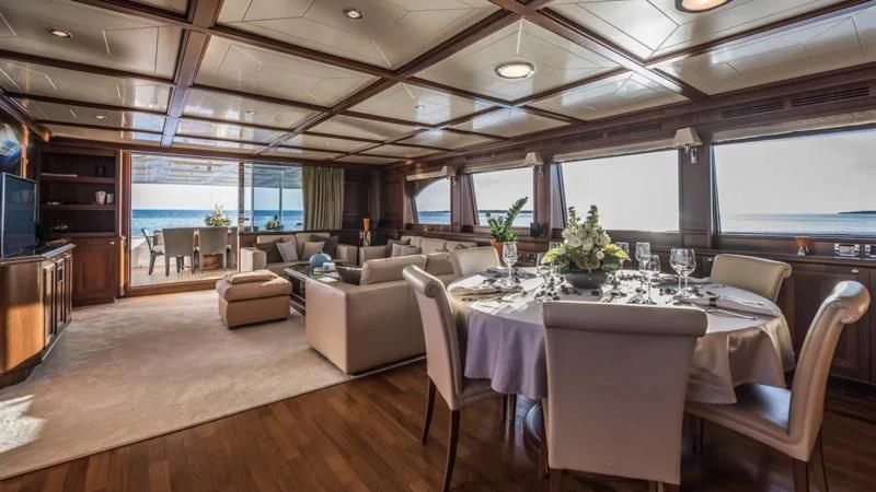 a large room with a table and chairs aboard KLOBUK Yacht for Charter