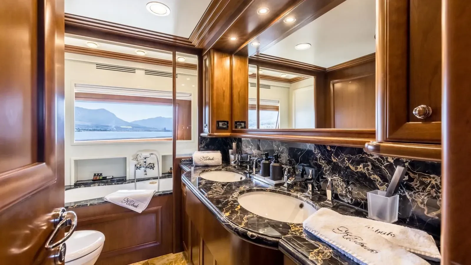 a bathroom with a countertop sink and a mirror aboard KLOBUK Yacht for Charter