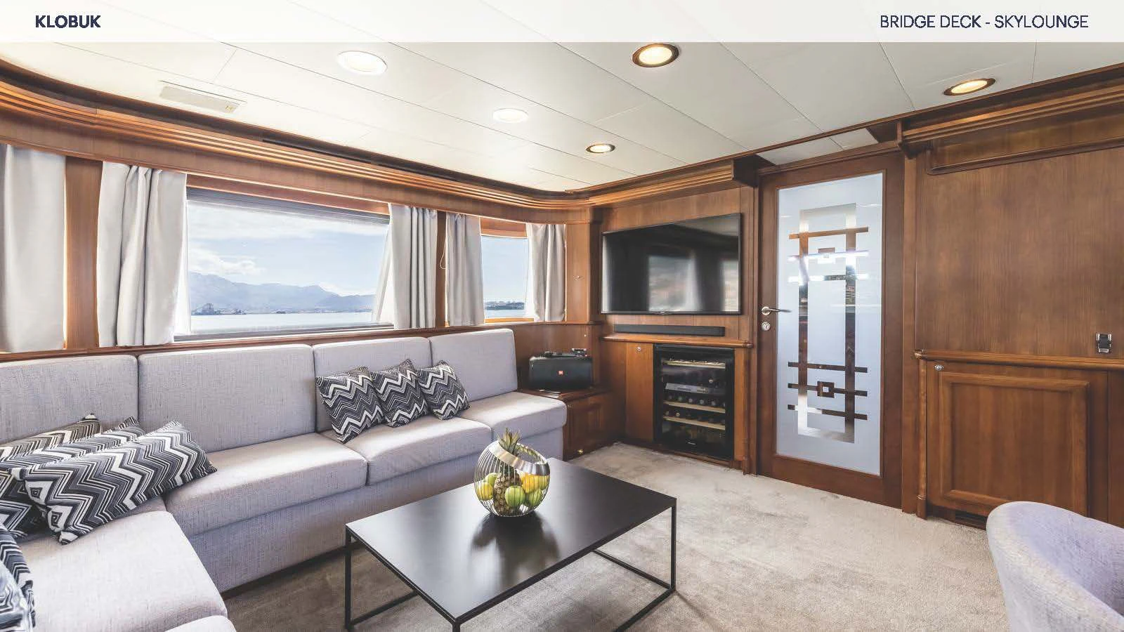 a living room with a couch and a coffee table aboard KLOBUK Yacht for Charter