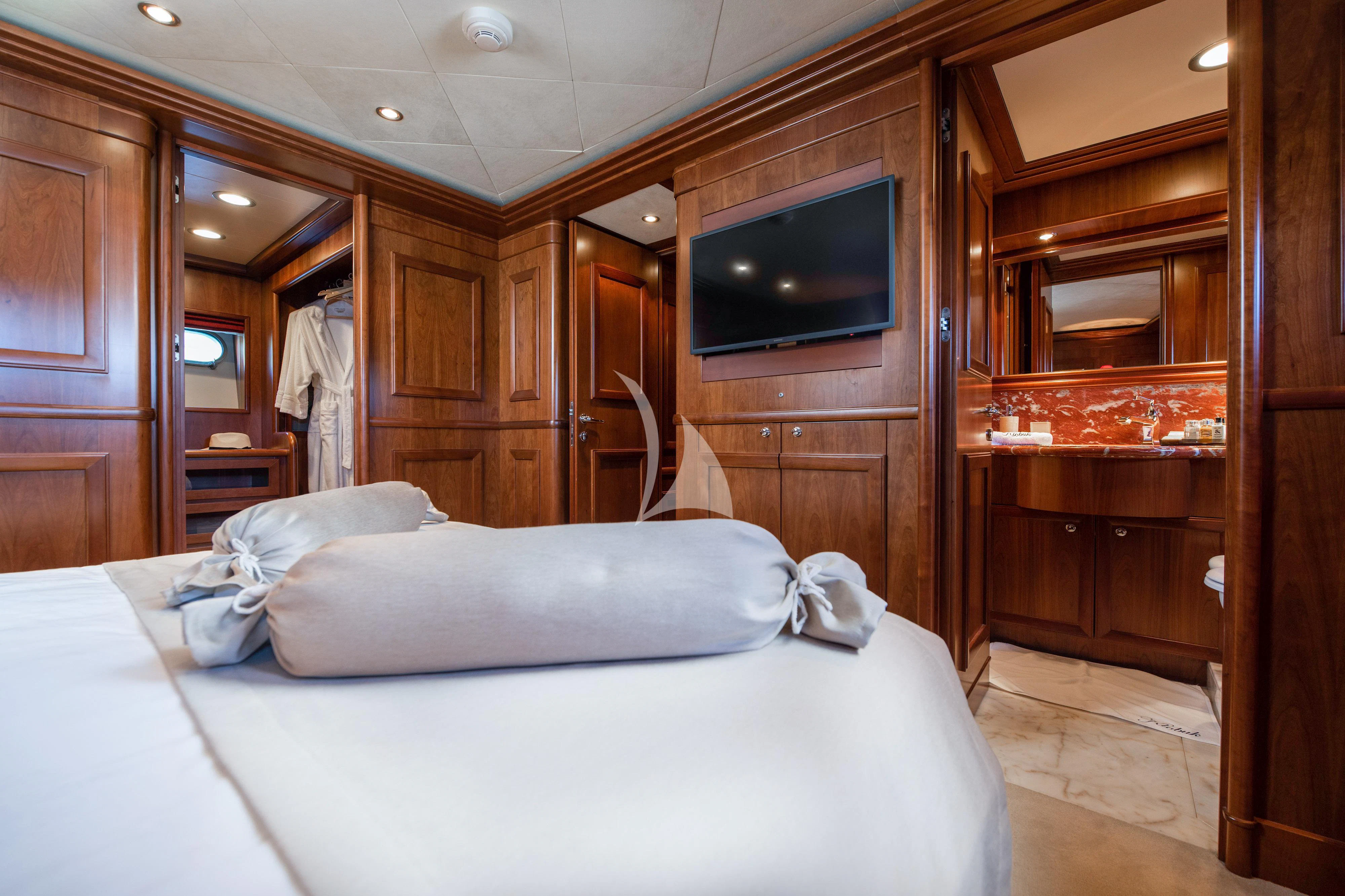 a bedroom with a television and a bed aboard KLOBUK Yacht for Charter
