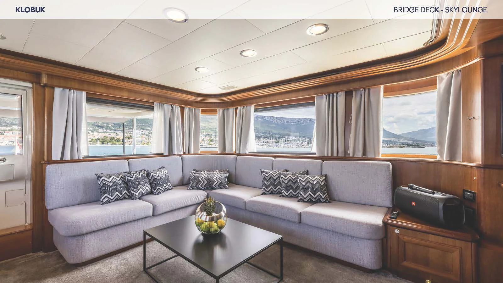 a living room with a couch and a coffee table aboard KLOBUK Yacht for Charter