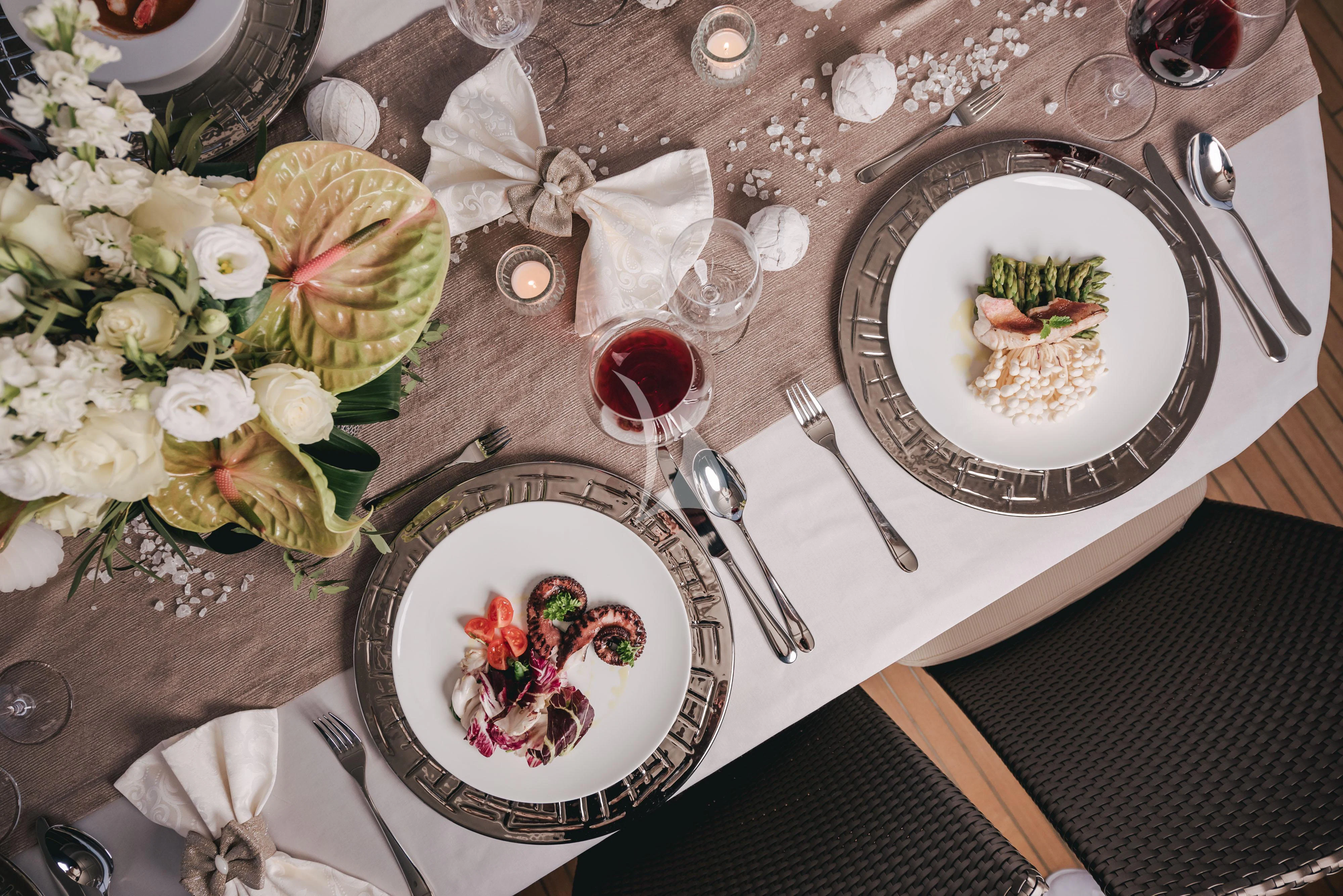 a table with plates and glasses aboard KLOBUK Yacht for Charter