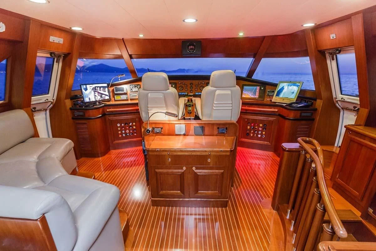 a room with a wood desk and chairs aboard KLOBUK Yacht for Charter