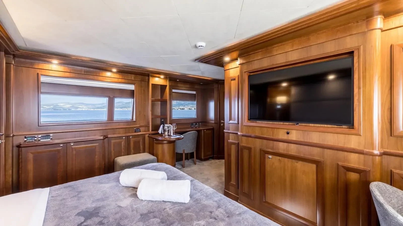 a hotel room with a bed and tv aboard KLOBUK Yacht for Charter