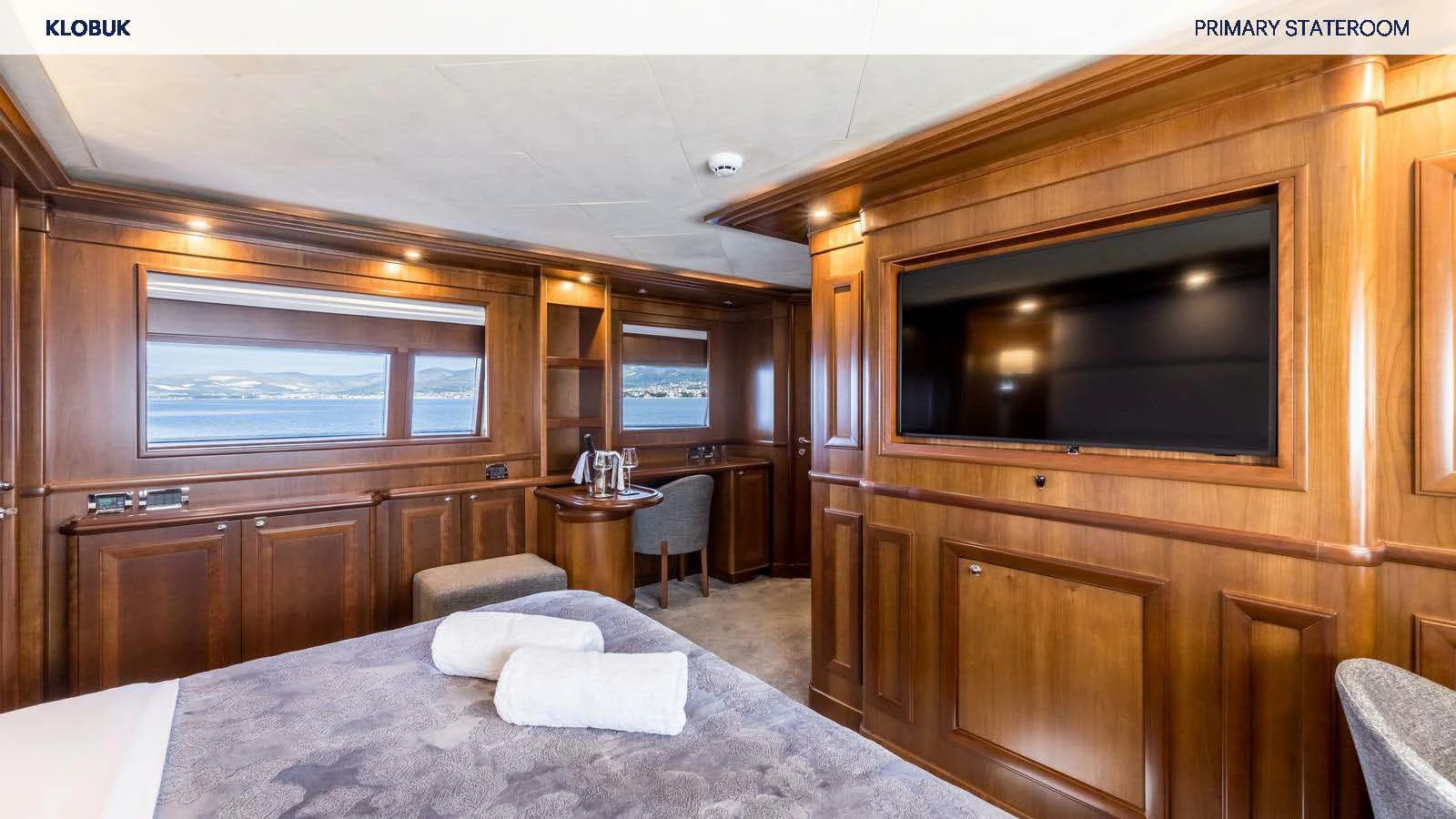 a hotel room with a bed and tv aboard KLOBUK Yacht for Charter