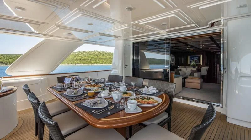 a dining table in a tent aboard KLOBUK Yacht for Charter