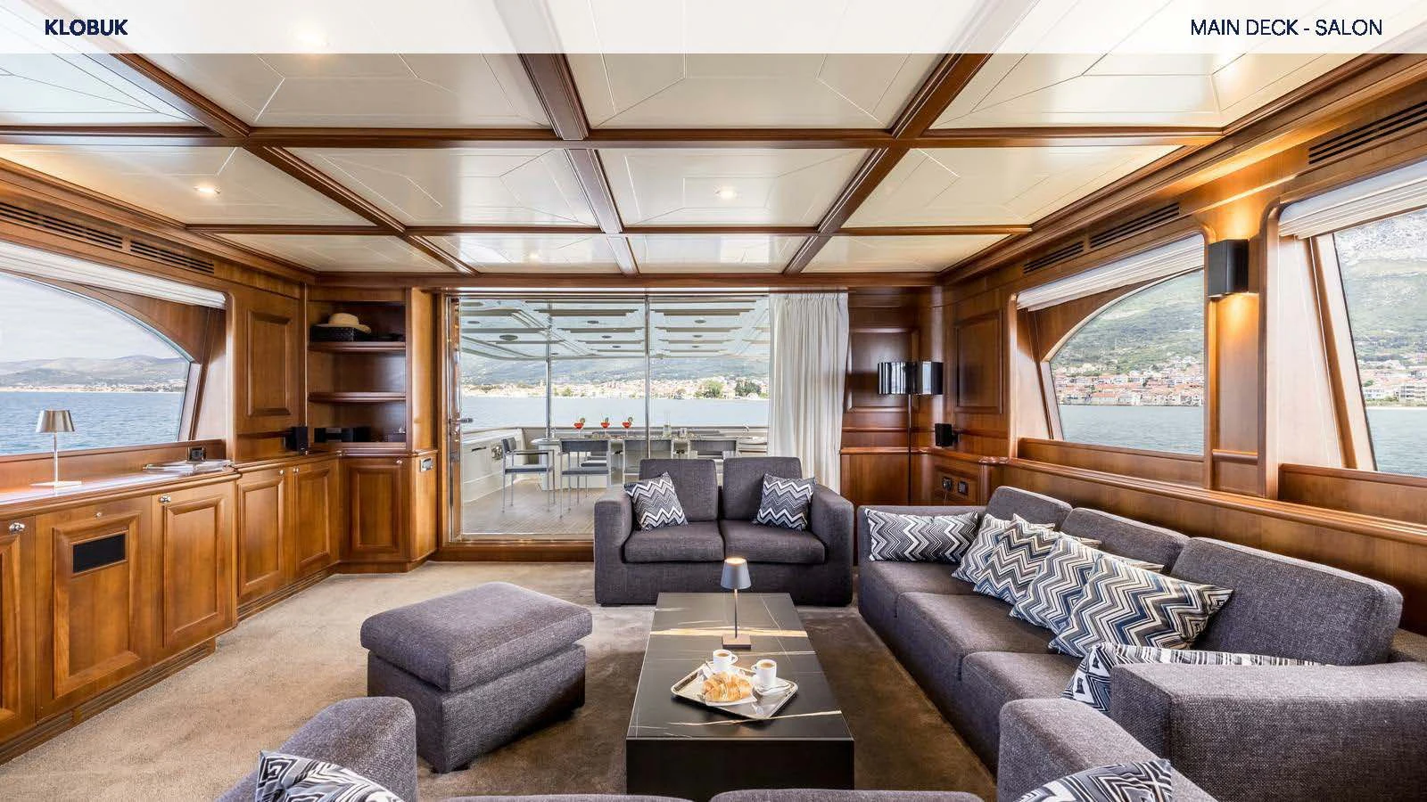 a living room with a couch and a coffee table aboard KLOBUK Yacht for Charter
