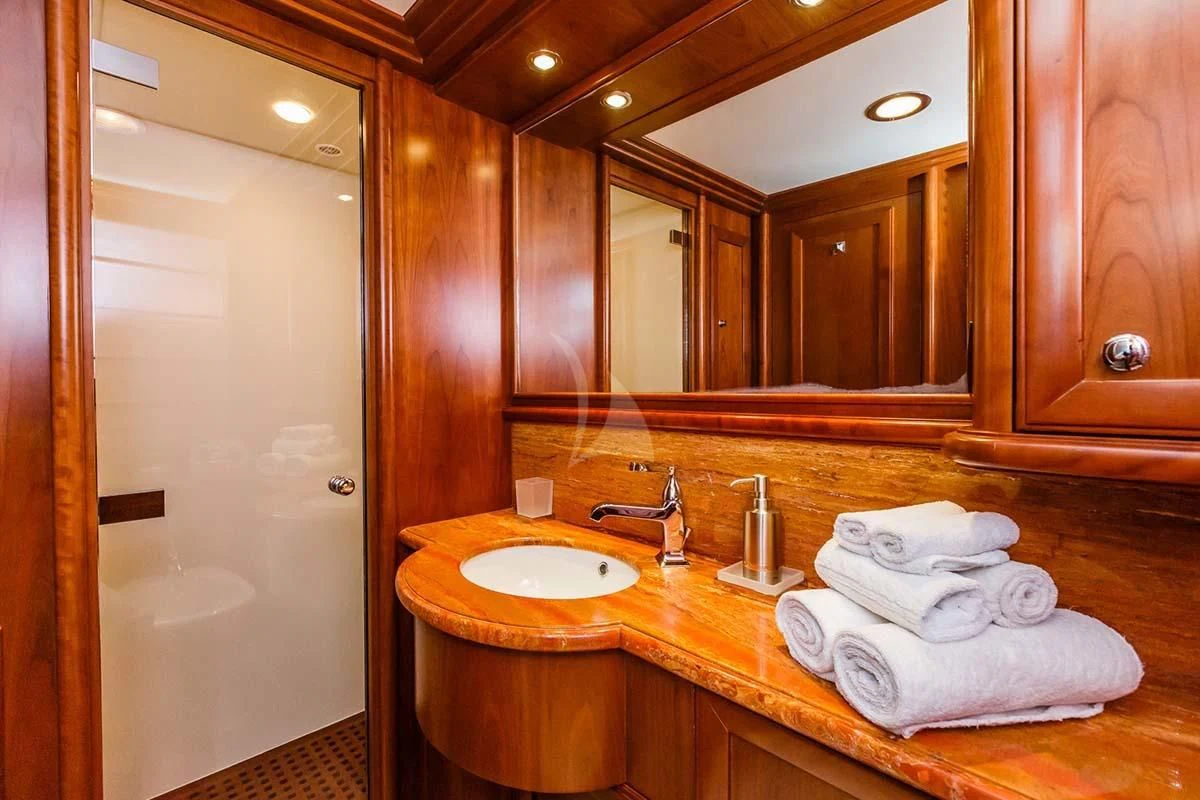 a bathroom with a sink and a mirror aboard KLOBUK Yacht for Charter