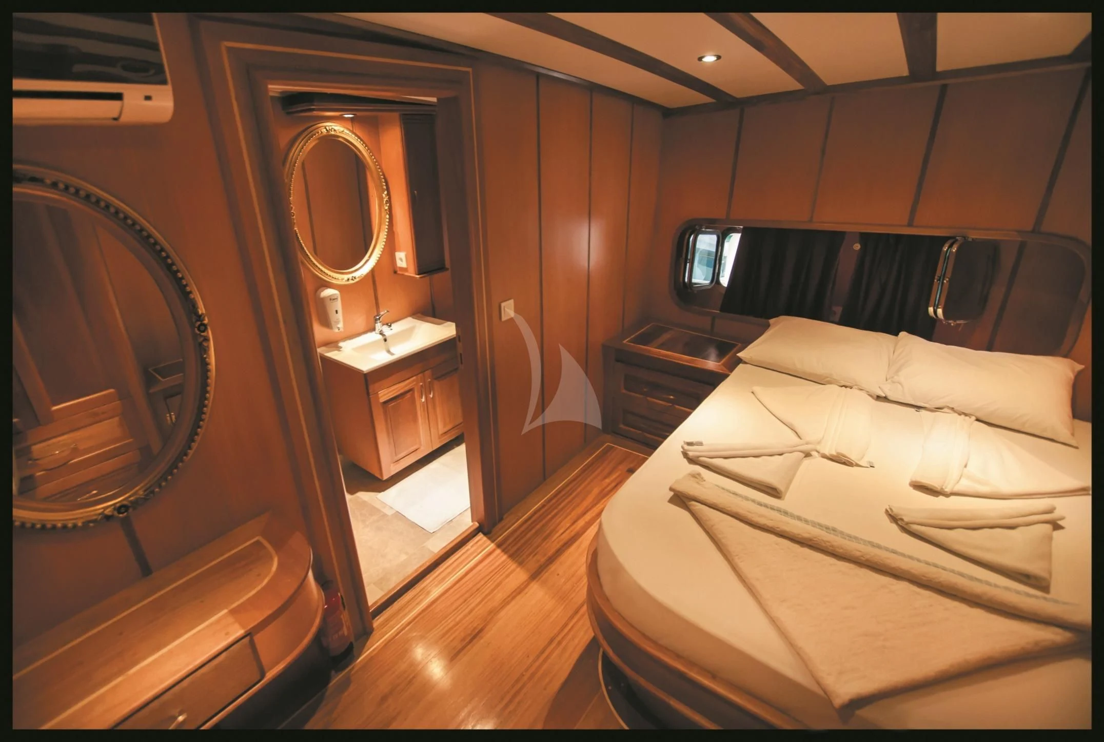 a room with a bed and a mirror aboard TERSANE 8 Yacht for Sale