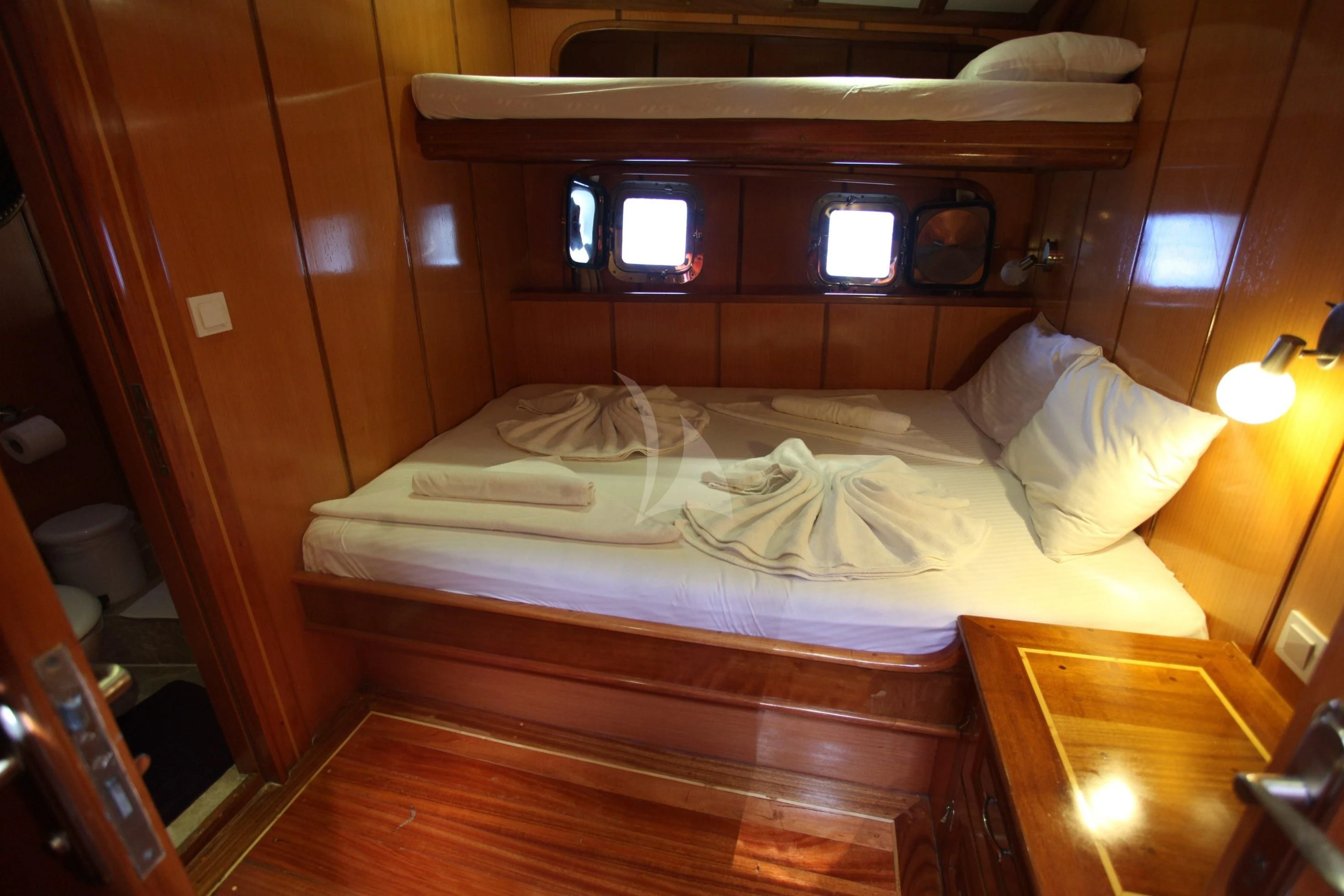 a bed with a white sheet and a wooden headboard aboard TERSANE 8 Yacht for Sale