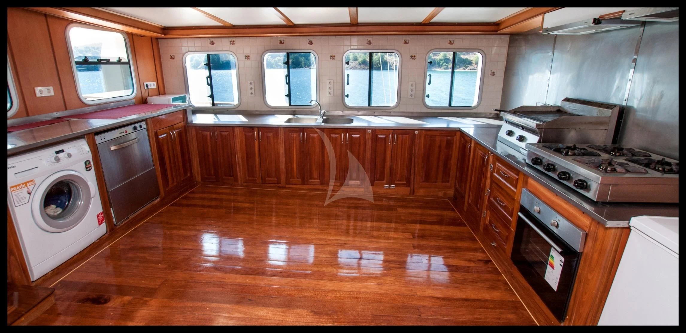 a kitchen with wooden cabinets aboard TERSANE 8 Yacht for Sale
