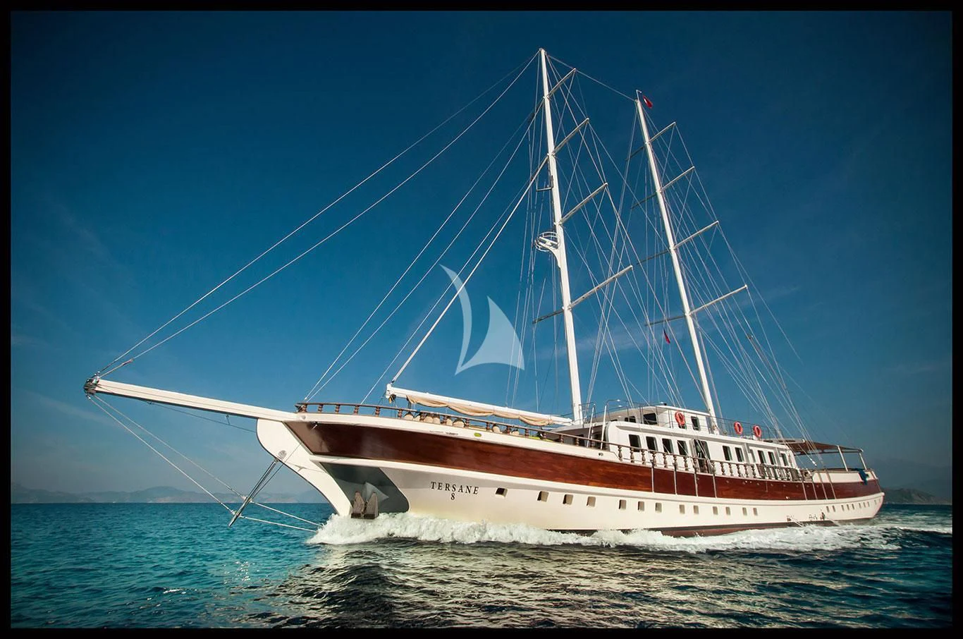 a large white boat with a large sail on the water aboard TERSANE 8 Yacht for Sale