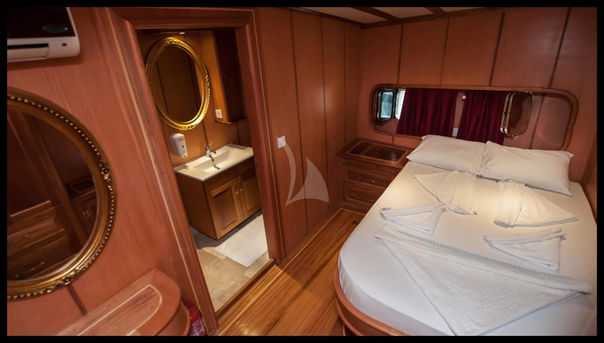 a room with a bed and a mirror aboard TERSANE 8 Yacht for Sale